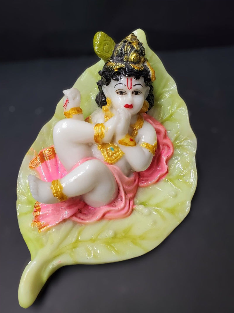 Baby Krishna on petal leaf